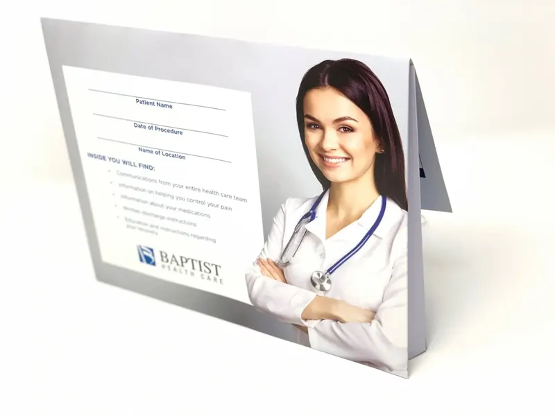 Baptist Health Care folder standing open, its interior printed with patient name, date of procedure and location fields