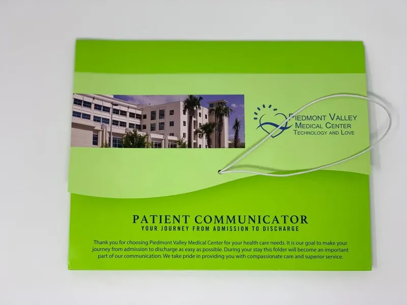 Green Piedmont Valley Medical Center Patient Communicator folder, closed, printed with the hospital exterior
